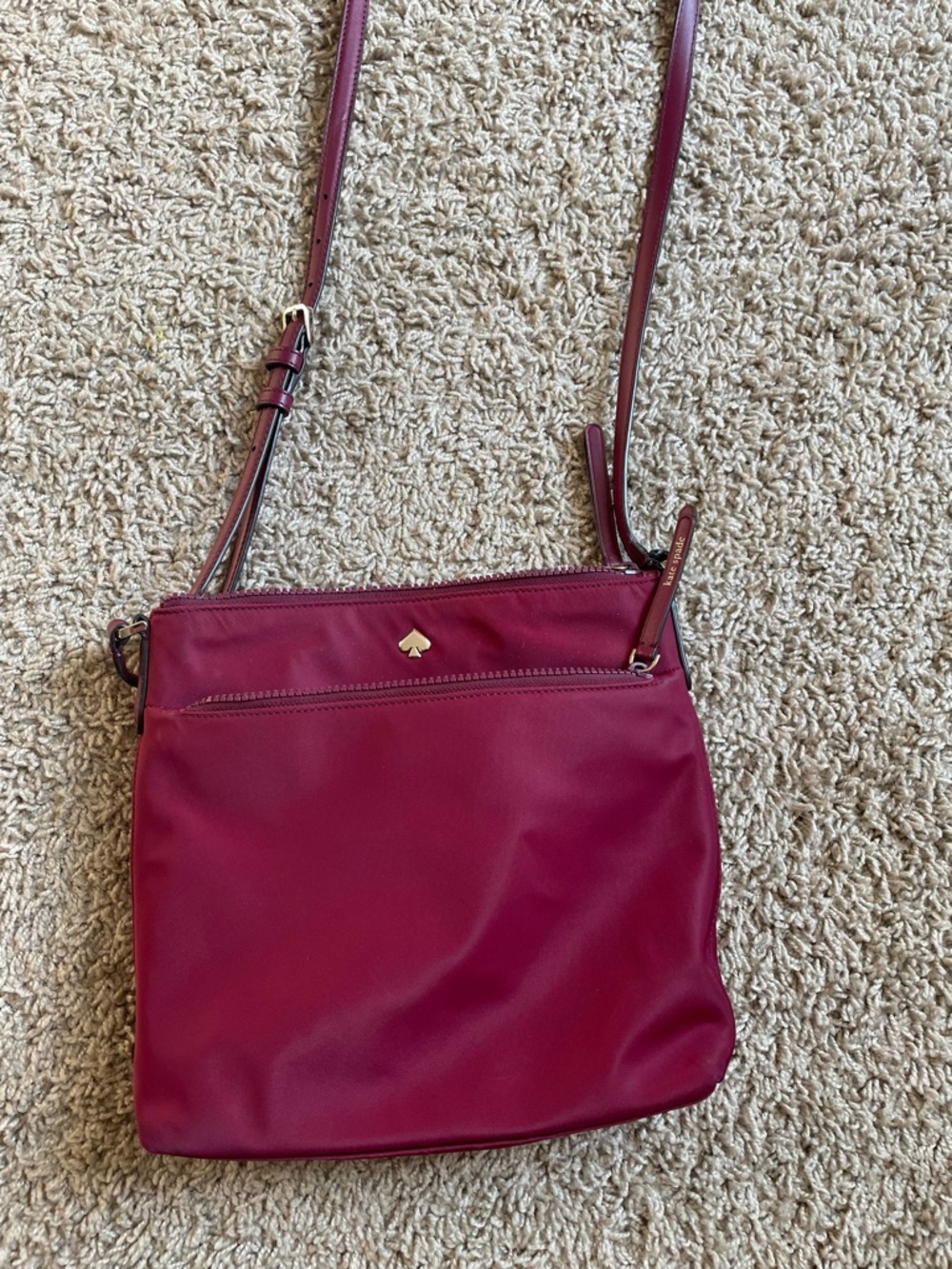 Kate Spade Woman’s Jae Flat Crossbody in Maroon in gently used condition